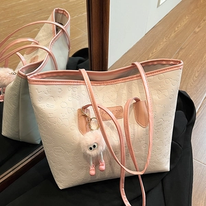 Chic beige tote bag with pink trim and embossed love patterns for stylish commuting