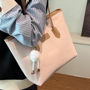 Pink embossed PU leather tote bag with plush ball charm and top handles