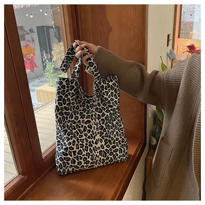 Close-up of leopard print canvas tote bag showing its large capacity and wide handle