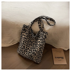 Detail shot of a large leopard print canvas tote bag with twin shoulder straps