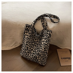 Detail of leopard print canvas tote bag showing thick texture and sturdy handles