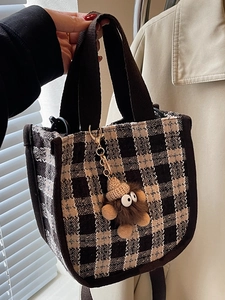 Fashion checkered canvas tote bag with brown straps and a cute plush monster charm detail