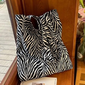 Large capacity canvas tote bag with bold black and white zebra print for daily commuting
