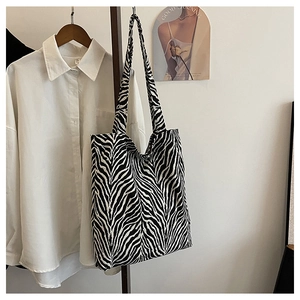 Close-up of large zebra print canvas tote bag with shoulder straps for daily use