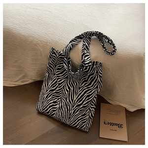 Close-up of zebra print canvas tote bag with textured fabric and spacious handle detail