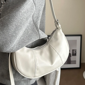 Chic off-white crescent underarm bag with decorative stitching and adjustable strap