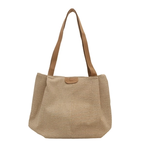 Large woven tote bag with leather straps and central logo patch for casual daily commuting