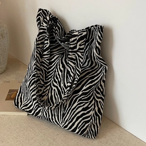 Chic zebra print canvas tote bag for women featuring large capacity and twin handles