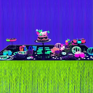 Neon purple and green foil fringe curtains for glowing Halloween birthday party decoration
