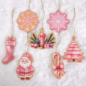 Set of 7 pink wooden Christmas tree ornaments with festive patterns on white faux fur