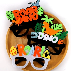 Three assorted dinosaur party glasses for kids on a wooden tray for birthday events