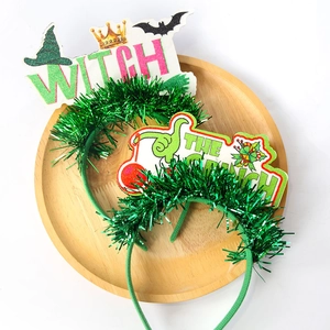 Detail of glitter WITCH and Grinch headbands for festive party decorations and photo props