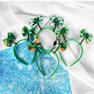 Set of three green St. Patrick's Day headbands with glitter shamrocks and festive bows