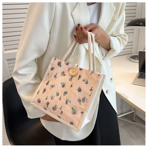 Detailed shot of pink floral canvas lunch bag with rustic wood button and cotton rope handle