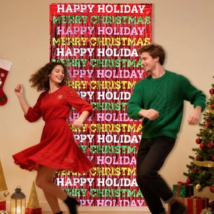 Detail of red metallic fringe curtain with printed Merry Christmas text for party decor