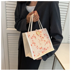 Detailed view of floral lace canvas lunch bag with wooden button and cotton rope handle