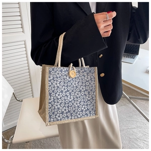 Detail of vintage floral bento bag with wooden button closure and cotton rope handles