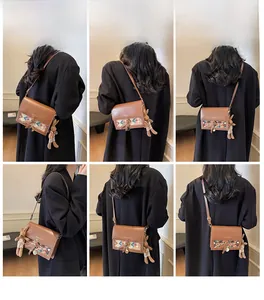 Brown vintage crossbody bag with geometric pattern and cute bunny plush charm detail
