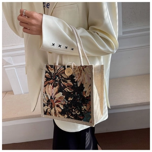 Detail of linen tote bag featuring retro floral print, rope handles and a wooden button