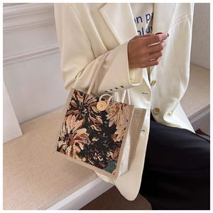 Detail of vintage floral jacquard pattern on a linen lunch bag with wood button closure