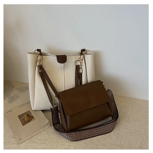Two-piece set with a cream tote bag and brown crossbody bag with geometric strap