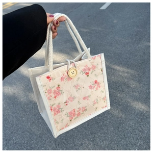 Detailed view of pastoral floral tote bag with wooden button and cotton rope handle