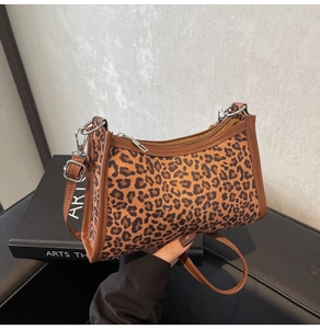 Dettaglio borsa a spalla leopardata con rifiniture marroni e cerniera in metallo argentato