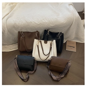 Detailed view of the 2-piece tote set showcasing various strap designs and leather textures