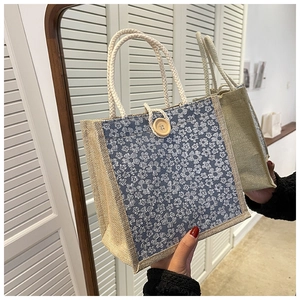 Close-up of linen lunch bag with floral fabric patch, wood button and rope handles