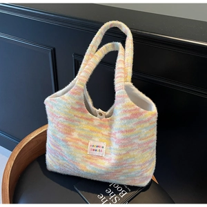 Macro detail of soft colorful knitted tote bag texture and white brand logo label
