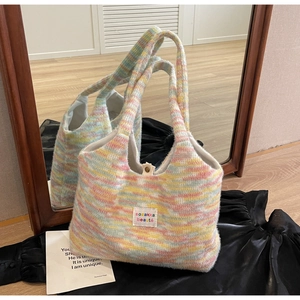Close-up of multicolor knit tote bag featuring soft fabric texture and button closure