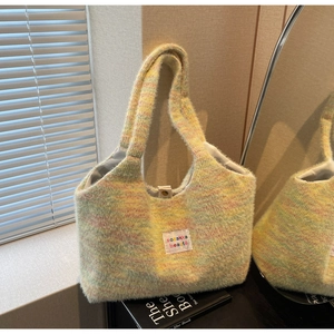 Macro view of fluffy knit tote bag with macaron blend texture and metal snap closure