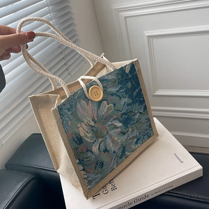 Linen canvas tote bag with blue floral embroidery and woven handles for women