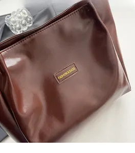 Detailed macro view of dark brown leather texture with Fashion & Bags logo patch