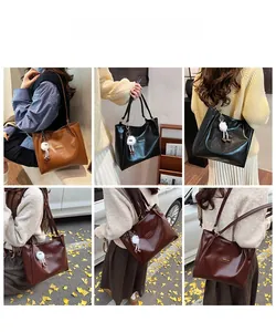 Detailed views of vintage large tote bag in brown, black and burgundy with plush charm