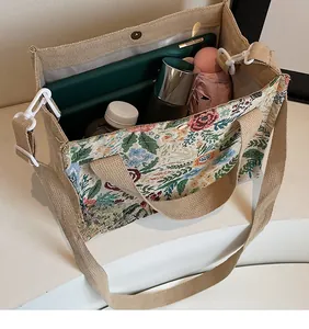 Spacious floral woven tote bag showing interior storage for tablets and bottles