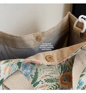 Detail view of the hidden magnetic buckle on a floral woven tote with linen texture