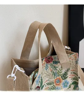 Macro detail of floral embroidery and herringbone lining on the canvas tote bag