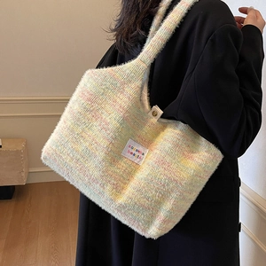 Colorful fuzzy knit tote bag with soft texture and front label shown on shoulder