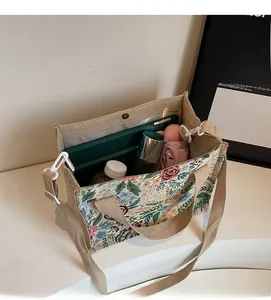 Top view showing the spacious interior of floral linen tote with cross-body strap