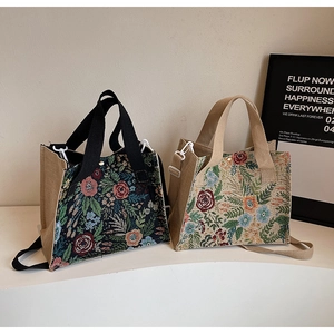 Detail of floral woven linen handbags showing rich jacquard texture and detachable straps