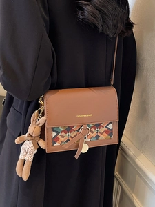 Vintage brown crossbody flap bag with geometric weaving and a cute rabbit pendant