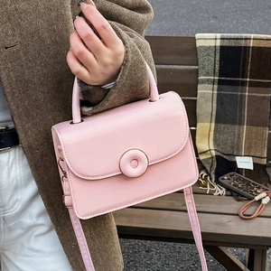 Fashionable light pink flap handbag for women with round buckle and adjustable strap