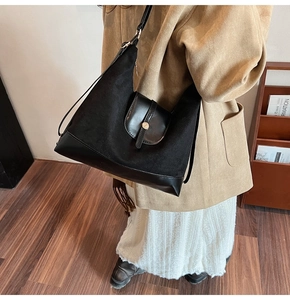 Close-up of black large capacity tote bag with suede and leather patchwork design