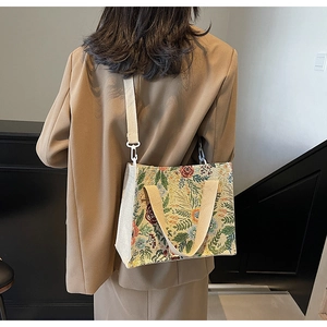 Detail of floral tapestry weave texture and dual strap system on a linen tote bag