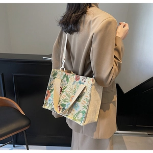 Floral jacquard tote bag with linen stitching and adjustable white shoulder strap details