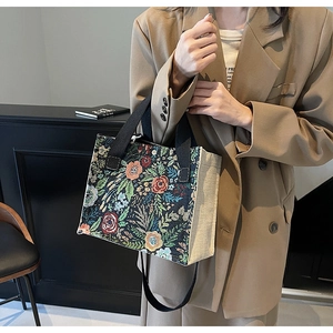 Detailed view of floral jacquard embroidery pattern on vintage style medium tote bag