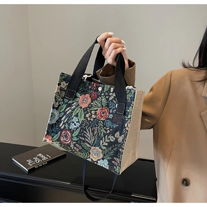 Detail of vintage floral jacquard pattern and natural jute canvas texture on the tote bag
