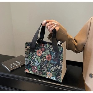 Detailed view of vintage floral jacquard pattern and durable woven canvas on a tote bag