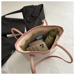 Internal view of tote bag showing large capacity with phone, wallet, and umbrella
